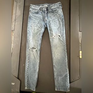 In new condition straight leg jeans with rips (all offers will be considered)
